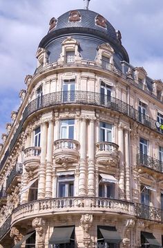 an ornate building with balconies on the top