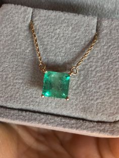 Square Cut Colombian Emerald Solitaire Pendant Drop Necklace in 14K Yellow Gold. This necklace features a medium green natural Colombian emerald, clarity: SI, Weight 1.68 Carat, Square Shaped 7.0mm x 7.0mm prong-style setting. Wheat Chain 14K Yellow Gold 16.5" total pendant necklace weight 2.55g Emeralds typically contain inclusions that are visible to the unaided eye. Because of this, trade members and some consumers understand and accept the presence of inclusions in emeralds. Eye-clean emeralds are especially valuable because they’re so rare. Emerald inclusions are often described as looking mossy or garden-like. They’re sometimes called "jardin,” which is French for garden. Formal Emerald Necklaces With Diamond Cut, Emerald Pendant Necklace With Diamond Cut, Fine Jewelry Green Diamond Cut Necklaces, Emerald Necklace With Diamond Cut In Fine Jewelry Style, Luxury Green Emerald Necklaces, Formal Hallmarked Emerald Necklace, Green Diamond-cut 14k Gold Necklace, 14k Gold Green Diamond Cut Necklace, Elegant Hallmarked Green Emerald Necklace