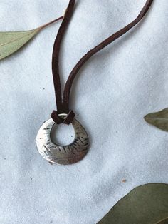 Whether you're strolling along the shore or simply daydreaming of beach days, this necklace captures the essence of laid-back style and natural beauty. Lightweight and versatile, it's designed to be your go-to accessory for effortless sophistication. Each silver pendant is hand-stamped with a unique texture, making every necklace a one-of-a-kind treasure. The subtle yet distinctive pattern adds a touch of artisanal charm, perfect for complementing any summer outfit or adding a bit of coastal fla Minimalist Adjustable Necklaces For Beach, Everyday Bohemian Charm Necklace With Round Pendant, Bohemian Round Pendant Necklace For Everyday, Everyday Bohemian Round Necklace, Bohemian Round Necklace For Everyday, Bohemian Round Necklace For Everyday Wear, Bohemian Jewelry With Adjustable Cord, Everyday Bohemian Jewelry With Adjustable Cord, Bohemian Sterling Silver Necklaces For Everyday