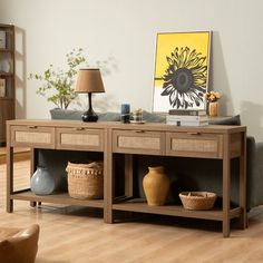 a living room with a couch, table and vases on the floor in front of it