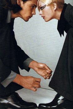 two people are touching each other with their hands