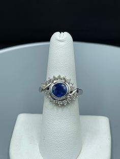 This is a beautiful 18k white gold Burma Sapphire and Diamond ring.  The vivid royal blue Burmese no heat Sapphire weighing 2.37 carat is an eye shaped gem. There are lovely clean and colorless Diamonds surrounding the Sapphire. The clarity of the diamonds are VS1 and they are H-J color. This truly unique creation would be a great addition to any fine jewelry collection or a gift for that someone special. This item is new and unworn. Gia Certified Sapphire Cluster Jewelry, Luxury Sapphire Ring With Round Stone, Gia-certified Cluster Sapphire Ring With Diamond, Gia Certified Cluster Sapphire Ring With Diamond, Exquisite Tanzanite White Gold Jewelry, Platinum Diamond Ring With Round Cut Gemstone, Round Cut Diamond Ring In Platinum, Luxury Round Sapphire Ring, Gia Certified Cluster Sapphire Ring