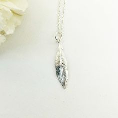 Introducing our Silver Feather Necklace! This dainty piece of feather jewelry featuring a beautifully detailed feather pendant is sure to catch attention. With its shiny finish that glimmers in the sunlight, this simple necklace adds a dash of elegance to your everyday wear. The necklace, along with the pendant, is crafted using pure 925 sterling silver ensuring durability and longevity. You can select the necklace length as per your comfort from our menu. Be it a casual brunch or a dinner date, this flowing feather pendant layering necklace in silver 925 will perfectly complement any outfit. ♡ DETAILS  Feather. 3 cm Material:  925 Sterling Silver The jewelry is made entirely of 925 sterling silver or  24K gold plated  elements. Gold plated is a sterling silver 925 coated with 24K gold. Th Silver Feather Necklace, Travel Necklace, Layered Necklaces Silver, Feather Necklace, Jewelry Simple, Feather Jewelry, Feather Pendant, Discount Jewelry, Silver Feather