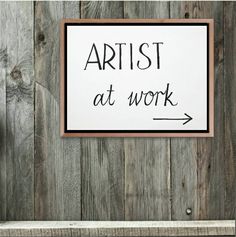 a sign that says artist at work on it