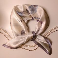 Discover timeless elegance with our exquisite silk scarf from Silquora. Handmade from high-quality silk, this scarf combines luxury and style at the highest level. A must-have accessory for every occasion. Our Silquora silk scarf is more than just an accessory - it's a statement of sophistication and taste. Each scarf is carefully handcrafted from the finest silk, creating a luxurious texture and silky sheen. From elegant evening events to casual outings on the town, this scarf will add unparall Elegant Beige Square Silk Scarf, Elegant Cream Silk Scarf, Elegant Silk Square Scarves, Elegant Beige Silk Scarf For Gift, Cream Silk Scarf For Formal Occasions, Elegant Spring Silk Scarf With Satin Finish, Elegant Cream Silk Scarf For Spring, Elegant Satin Scarves As Gifts, Elegant Beige Silk Scarf For Formal Occasions