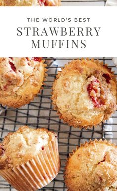 several muffins on a cooling rack next to a plate with strawberries in it