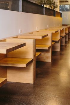 several wooden benches lined up against the wall