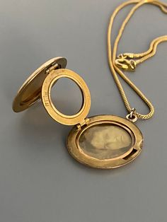 "Weight: 11.9g Dimensions: 1\" round, 18\" chain Hallmarks: Makers mark L & M Although these lockets were patented in the year 1902, this particular locket states on its backside that it is from the 'class of '12' dating it to a decade later. This is a very unique locket in that it has 3 windows and folds like an accordion. All bezels are present and the two clear windows inside the front and back covers are still present. The locket measures 1\" round and comes on an 18\" GF chain. Very lig Vintage Oval Necklace With Coin Pendant, Victorian Style Medallion Coin Pendant Jewelry, Vintage Oval Jewelry With Coin Pendant, Victorian Round Locket Necklace Stamped 14k, Antique Medallion Locket Necklace Stamped 14k, Victorian Medallion Locket Necklace Hallmarked, Vintage Medallion Locket Necklace With Coin Pendant, Round Locket Necklace Collectible, Victorian Hallmarked Round Pendant Locket Necklace