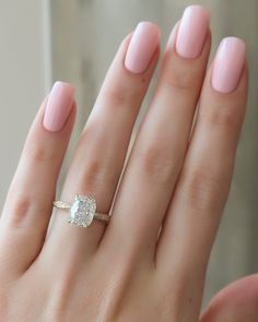 a woman's hand with a ring on it and a diamond in the middle