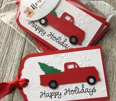 two christmas cards with a red truck and tree on the front one has a happy holidays tag