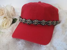 I designed this light weight red trucker baseball hat with gorgeous rhinestone and beaded trim. Perfect for those bad hair days. Has a adjustable pony tail back. See more of my trucker baseball cadet hats here: https://www.etsy.com/shop/theraggedyrose?ref=seller-platform-mcnav&section_id=10557807 Thanks for visiting my shop Adjustable Baseball Cap With Bling, Casual Adjustable Baseball Cap With Rhinestones, Rhinestone Baseball Cap One Size, Rhinestone Embellished One Size Baseball Cap, Adjustable Rhinestone Baseball Cap With Curved Brim, Trendy Rhinestone Adjustable Baseball Cap, Adjustable Rhinestone Cap, Red Adjustable Fitted Hat With Short Brim, Red Adjustable Fitted Baseball Cap