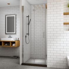 a bathroom with a sink, mirror and shower stall in it's corner area