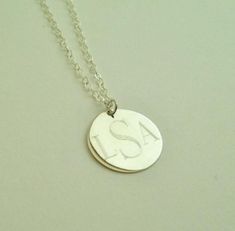 "This sterling silver necklace makes a beautiful present for your wife, mother or friend. They are also perfect for for bridesmaids presents. I will engrave a monogram or name onto the round pendant. Pendant - Sterling Silver, 3/4\" diameter Necklace- Sterling Silver, 16\" long (if you prefer longer or shorter please request at checkout, for up to 20\" there is no additional charge, longer will be charged $2 per inch) How to Order: 1. Place item or items in cart. (If purchasing more than one ite Adjustable Silver Name Necklace With Round Pendant, Elegant Silver Name Necklace With Engraving Option, Silver Name Necklace With Round Pendant, Adjustable Sterling Silver Initials Name Necklace, Silver Adjustable Round Pendant Name Necklace, Sterling Silver Pendant Name Necklace With Engraving, Sterling Silver Name Necklace With Engraving Option, Silver Sterling Name Necklace With Engraving Option, Adjustable Sterling Silver Name Necklace With Round Pendant