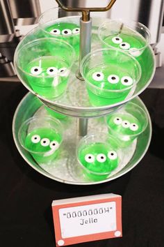 some green cups with googly eyes on them