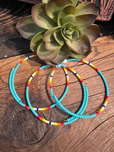 This stylish Serape Wrap Bracelet ~ Turquoise is a dainty western-inspired piece that's handcrafted by a small business in the USA. Featuring serape beads that wrap around your wrist, it's a unique and fashionable accent for any outfit. Wear alone or stack with other colors to make the perfect western stack. Shown with our Laney Earrings Adjustable Turquoise Wrap Bracelet With Tiny Beads, Handmade Turquoise Round Beaded Bracelets, Handmade Round Turquoise Beaded Bracelets, Traditional Turquoise Hand-wrapped Jewelry, Traditional Turquoise Hand Wrapped Jewelry, Southwestern Hand Wrapped Adjustable Jewelry, Southwestern Adjustable Hand Wrapped Jewelry, Adjustable Southwestern Hand Wrapped Jewelry, Adjustable Southwestern Style Hand Wrapped Jewelry