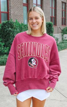 Score a touchdown with The Florida State 'Emily' Jersey Tee! This relaxed fit tee combines the comfort of a t-shirt with the look of a jersey, perfect for game day. Show off your love for football and look cute while doing it. Go Noles! Details: *OFFICALLY LICENSED* Super Soft, Classic Knit tee 55% Cotton, 45% Polyester Crew Neckline, Jersey styling, Longer length Short Sleeves, Waist Length tee Features Oversized Seminole graphic, center chest Color: Garnet True to Size: Relaxed fit, Boxy Cut N Collegiate Short Sleeve Jersey For Game Day, Collegiate Fleece Tops For Game Day, Team-colored Fleece Top For Game Day, Jersey Styling, Team-colored Long Sleeve T-shirt For Game Day, Florida State Seminoles Shirt, Vintage Fleece, Tallahassee Florida, Fashion Bottoms