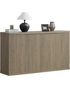 the sideboard is made out of wood and has a lamp on top