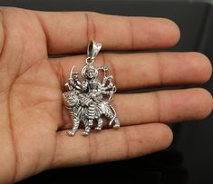 Divine 92.5 sterling silver Indian Hindu Idols Blessing Goddess Bhawani/Durga/Santoshi maa with lion vintage antique style stunning divine pendant, best gifting unisex jewelry from India. Metal-925 sterling silver. Item type-Pendant/ Locket Weight-9.250 grams. Height-4.8 centimeter. Width-2.7 centimeters. Stamped-925. Finish-Oxidized. note :chain is not include in this price, to purchase chain please visit following links: https://www.etsy.com/listing/823425858/16-to-30-long-screw-chain-925-ster Symbolic Jewelry For Navratri Rituals, Symbolic Jewelry For Navratri Puja, Symbolic Jewelry For Puja And Navratri, Hallmarked Jewelry For Puja And Navratri, Spiritual Oxidized Jewelry For Navratri, Symbolic Jewelry For Puja And Diwali, Symbolic Jewelry For Diwali Puja, Symbolic Jewelry For Puja During Diwali, Silver Symbolic Jewelry For Diwali