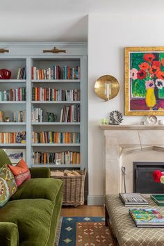 a living room filled with furniture and bookshelves next to a fire place in front of a fireplace