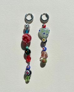 Limited Edition Midnight Sun Collection. Stranded offset vintage murano beads, glass beads with stainless steel hoop (13mm) earrings. The full earring length is 3,5 inches and 3 inches. The colors may vary. Hand-made by Karo at her home studio. Y2k Beaded Earrings, Fun Diy Jewelry, Earings Home Made, Beaded Earing Designs, Colorful Beaded Earrings, Funky Beaded Earrings, Cute Things To Make With Beads, Glass Beaded Earrings, Glass Pearl Jewelry Ideas