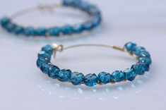 London blue topaz, 14k gold filled/ sterling silver. Beautiful blue topaz hoop earrings. Made with facet Swiss blue topaz (coated) rondelle beads, 14k gold-filled or sterling silver wire. The topaz beads have unique dark blue color, and the tiny facet cut adds beautiful sparkles to the earrings. Very lightweight as significant hoop earrings. The earring's diameter can be made in 2 inches, 1.5 inches, and  1.2 inches. The one in the photos measures 1.5 inches. Please feel free to contact me with any customization requests.   -Shipping- The item was usually shipped within 1-2 business days. Customized items may take longer.  Free shipping on all domestic US orders. Ship worldwide. The cost may vary due to the shipping method.   -Gift wrapping- Each product is well packed in a decent gift box Hoop Earrings Gold, November Birthstone, Dark Blue Color, Swiss Blue Topaz, Opal Earrings, London Blue Topaz, London Blue, Jewelry Earrings Hoops, Silver Hoops