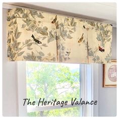 a kitchen window with birds on the valance