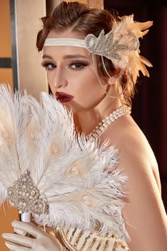 a woman in a white dress with feathers on her head and gloves around her neck