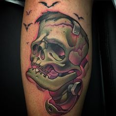 a tattoo with a skull and a snake on it