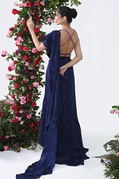 Midnight blue attached cancan ruffed lehenga saree with all over crystal drops embellishments and an attached drape. Paired with a backless halter neck padded blouse with multi colored sequins bloom embroidery. - Aza Fashions Party Pre-draped Floor-length Lehenga, Pre-draped Georgette Dress With Zari Work, Evening Ruffled Dress For Diwali, Festive Pre-draped Dress With Dupatta, Pre-draped Georgette Lehenga For Designer Wear, Pre-draped Dupatta Dress For Reception, Pre-draped Dresses With Zari Work, Pre-draped Dress With Dupatta For Reception, Pre-draped Reception Dress With Dupatta