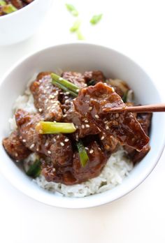 a white bowl filled with beef and rice