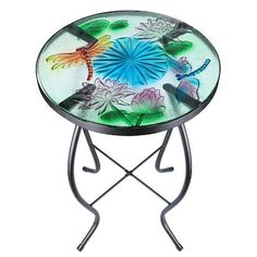 a glass side table with dragonflies and lily pads on the top, sitting on a metal stand