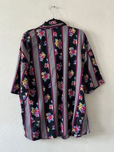 Oversized short sleeve printed button up tee. Unlined and in excellent vintage condition. DETAILSLabel: Royal DesignSIZE & MEASUREMENTSBest Fits: M/LLength: 32"Bust: 52"Waist: 50"Sleeve: 10"Shoulder: 26" Multicolor Floral Print Short Sleeve Camp Shirt, Patterned Short Sleeve Shirt With Buttons, Casual Short Sleeve Blouse With Retro Print, Vintage Multicolor Short Sleeve Shirt, Multicolor Floral Print Short Sleeve Shirt With Camp Collar, Short Sleeve Shirt With Retro Print For Spring, Vintage Short Sleeve Blouse With Retro Print, Retro Short Sleeve Top With Vintage Pattern, Retro Patterned Short Sleeve Tops