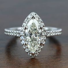 an oval cut diamond ring on a table