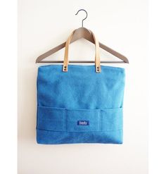 Large blue canvas tote bag shopping bag casual tote school bag book bag beige genuine leather strap classy bag for women. It's made from high quality blue canvas fabric. The straps made from genuine leather, pockets on the blue cotton lining and three on the front side. Tha bag has two way zipper closure. It's a perfect everyday bag.Port Deluxe collectionAll products are designed and handmade by me in a pet and smoke free environment.✦✦✦ DIMENSIONS ✦✦✦Width on the top: 40cm / 16,9 inchesHeight: Blue Canvas Shoulder Bag With Handles, Canvas Bags With Rolled Handles For Shopping, Everyday Use Canvas Bag With Double Rolled Handles, Everyday Canvas Bag With Double Rolled Handles, Blue Canvas Shoulder Bag, Canvas Shopping Bags With Rolled Handles, Modern Blue Cotton Bags, Blue Canvas Bag With Double Handle, Blue Canvas Satchel Bag With Handles