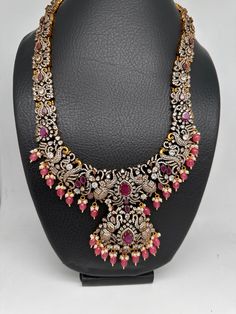 Victorian Mehndi Finish AD Polki Red Stone Pink Beads Long Statement Necklace with Matching Screwback EarringsColor : Victorian MehndiSize : Necklace Length : 24 Inches; Earring Length : 2 inches;Stones : AD Polki Red Stone Pink Beads Pearls Traditional Hand Set Pink Jewelry, Traditional Pink Hand Set Jewelry, Red Beaded Temple Jewelry Sets, Red Hand-set Chandbali Jewelry, Red Kundan Jewelry With Round Beads, Red Chandbali Jewelry With Intricate Design, Red Chandbali Necklace With Intricate Design, Bohemian Jewelry With Stone Work And Round Beads, Red Beaded Kundan Necklace For Wedding