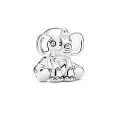 an elephant charm sitting on top of a white surface