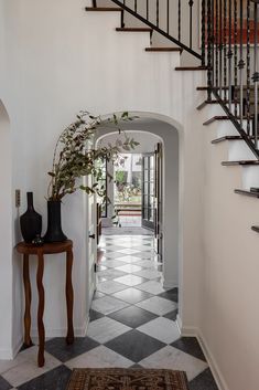 an entry way leading to a foyer with black and white checkered flooring