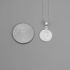 St. Benedict full-body image and a cross in the back Material that is extremely durable and hypoallergenic A powerful message of spiritual protection The front and back of this pendant are finely detailed, and the chain that it hangs from is no exception. The delicate details are embossed in a silver tone for better shine and shadowing for better contrast. This double-sided necklace is a must-have accessory. Pair this with any other necklace for a stylish and modern look. Dimensions & Specificat Catholic Cross Necklace, Saint Benedict Medal, Saint Necklace, St Benedict Medal, Catholic Necklace, Benedict Medal, Saint Jewelry, St Benedict, Saint Benedict