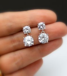 Tarnish resistant White gold plated metal framed AAA high quality clear white cubic zirconia round post earrings with AAA quality round drop clear white cubic zirconia pendant. Earring posts are surgical steel.. Size: top stone diameter: 6mm Bottom stone diameter: 8mm Matching necklace and bracelet available. https://www.etsy.com/listing/278176308/diamond-quality-solitaire-necklace-cubic?ref=listings_manager_grid https://www.etsy.com/listing/85607281/bridal-wedding-bracelet-christams?ref=shop_ho Simple Wedding Earrings, Small Earrings Gold, Diamond Charm Necklace, Round Diamond Earrings, Diamond Solitaire Earrings, Diamond Earrings Design, Solitaire Earrings, Jewelry Bridesmaid, Diamond Jewelry Designs