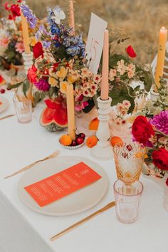 a table topped with lots of flowers and candles