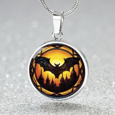 Embrace the darkness with our Personalized 18K Gold Vampire Bat Necklace. This charm pendant is the ultimate accessory for Gothic enthusiasts and Halloween lovers, adding the perfect touch of mysterious allure to your animal jewelry collection. ➜ Our patent-pending jewelry is made of high quality surgical steel with a graphic image that's printed directly onto the steel surface with a shatterproof liquid glass coating and includes an 18k gold finish option. There are no Gems in this product. ➜ O Vampire Style Necklace For Halloween, Handmade Vampire Style Necklace For Gift, Gold Fantasy Jewelry For Halloween, Gothic Round Pendant Necklace For Halloween, Gothic Halloween Jewelry With Round Pendant, Gothic Halloween Round Pendant Jewelry, Symbolic Halloween Jewelry Pendant, Symbolic Halloween Pendant Jewelry, Symbolic Pendant Jewelry For Halloween