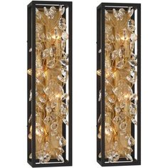 two wall sconces with lights on them in gold and black metal finish, one is