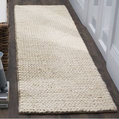 a white rug is on the floor next to a basket