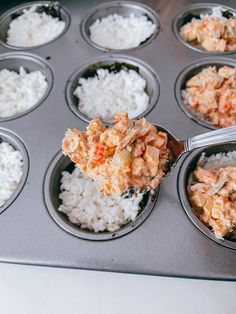 a muffin tin filled with lots of different types of food on top of it