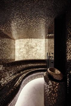 a very fancy bathroom with mosaic tile on the walls