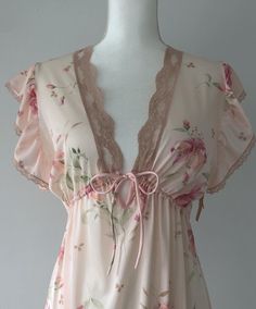 Stunning vintage 70s nightie/lingerie, and deadstock on top of it all! Adding a slip could easily turn it into a day dress. Still has original hang tags attached at the left arm. Sheer, nylon, adjustable in the under bust. Light pink, airy, dreamy ruffled shoulders. Flawless condition. Plenty of stretch.  Shoulders 15" Chest 19-21" (stretches) Ribs/underbust adjustable with tie Length (shldr to hem) 53" I would say this would suit anyone XS-M.  Super romantic and gorgeous! NEW ITEMS WEEKLY!  Come visit me on Instagram to have access to items before they are posted to the Etsy shop.  @rubyhausvintage All of the items I sell are pre-loved, which means that signs of wear are to be expected.  This brings unique character to an item! I do my best to note any major flaws I find in the item descr Sheer V-neck Coquette Sleepwear, Fitted Sheer Sleepwear For Loungewear, Sheer Fitted Sleepwear For Spring, Fitted Sheer Sleepwear For Spring, Sheer Fitted Nightgown For Spring, Sheer Coquette Sleepwear For Summer, Sheer Fitted V-neck Sleepwear, Sheer Coquette Summer Nightgown, Fitted Feminine Nightgown With Floral Print