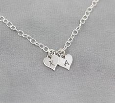 This sweet bracelet, featuring your initials engraved on Sterling Silver hearts, is sure to make her smile. Show her your love by personalizing this Sterling Silver bracelet as a thoughtful gift for a birthday, anniversary or Christmas. The Sterling Silver chain can be cut to your preferred length (standard is 7 1/2") and features an adjustable clasp so that she can adjust it to fit.TO ORDER -- Please select the initials that you would like from the drop down menus. Please include the length tha Personalized Sterling Silver Heart Friendship Bracelet, Sterling Silver Name Bracelet With Heart Charm For Gift, Personalized Double Heart Sterling Silver Bracelets, Personalized Heart Charm Bracelet For Friendship, Personalized Sterling Silver Double Heart Bracelets, Personalized Sterling Silver Double Heart Bracelet, Personalized Sterling Silver Heart Bracelet, Personalized Heart Bracelet For Friendship, Personalized Charm Bracelet For Friendship On Valentine's Day