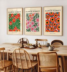 three flower market posters on the wall above a dining room table