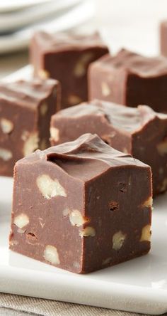 four pieces of chocolate fudge on a white plate