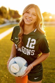 a girl holding a soccer ball in her hands